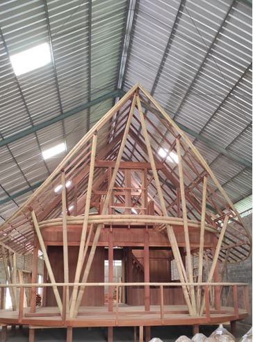 Wood and bamboo roof frame of a Magic Wood prefab home taking shape at the Bali production workshop